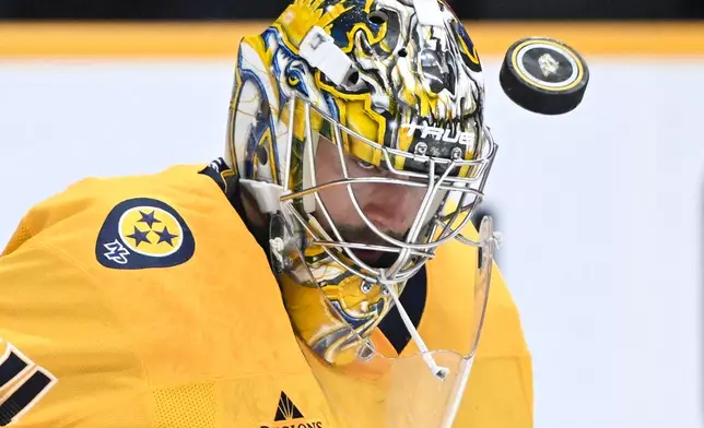 Nashville Predators goaltender Juuse Saros (74) makes a save against the New York Islanders during the first period of an NHL hockey game Tuesday, Oct. 27, 2026, in Nashville, Tenn. (AP Photo/John Amis)
