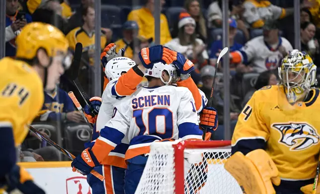New York Islanders center Brayden Schenn (10) is congratulated after scoring a goal against the Nashville Predators during the first period of an NHL hockey game Tuesday, Oct. 27, 2026, in Nashville, Tenn. (AP Photo/John Amis)