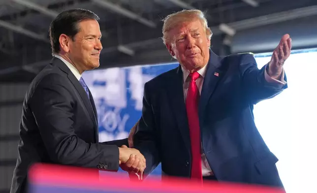 President Donald Trump greets Secretary of State Marco Rubio at a campaign rally at the Port of Corpus Christi, Tuesday, Oct. 27, 2026, in Corpus Christi, Texas. (AP Photo/Alex Brandon)