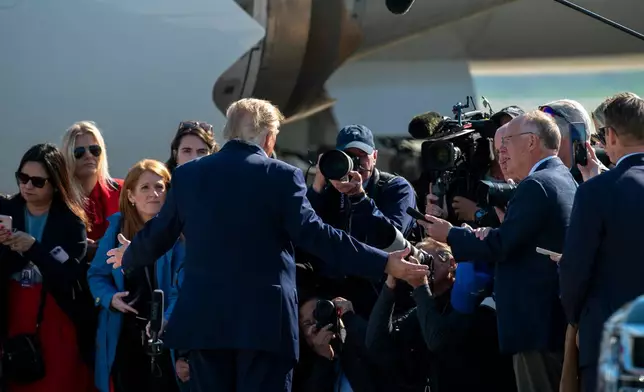 President Donald Trump speaks with media before boarding Air Force One at Joint Base Andrews, Md., Tuesday, Oct. 27, 2026. (AP Photo/Cliff Owen)