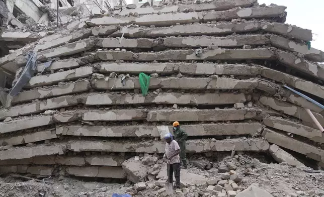 Security forces and civil defense work after a multi-story building collapsed in Nairobi, Kenya, Friday, Oct. 23, 2026. (AP Photo/Brian Inganga)