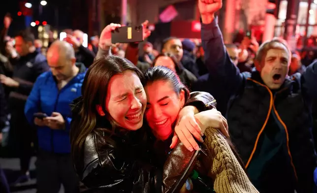 People celebrate after Aleksandar Vucic, leader of the right-wing Serbian Progressive Party (SNS) conceded defeat in the parliamentary election in Belgrade, Serbia, Sunday, Oct. 25, 2026. (AP Photo/Marko Drobnjakovic)