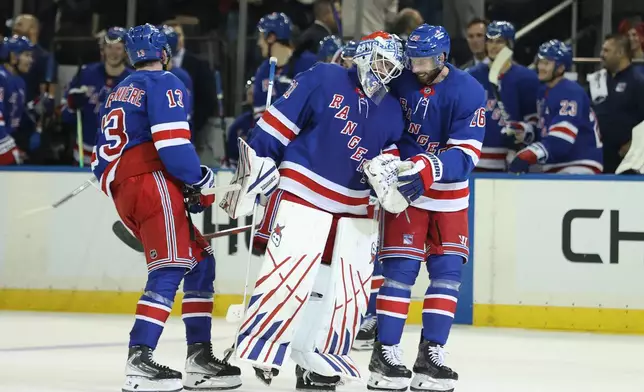 New York Rangers goaltender Igor Shesterkin (31) and New York Rangers' Marcus Pettersson (26) react after Shesterkin scored a goal during the third period of an NHL hockey game against the Tampa Bay Lightning Thursday, Oct. 1, 2026, in New York. (AP Photo/Pamela Smith)