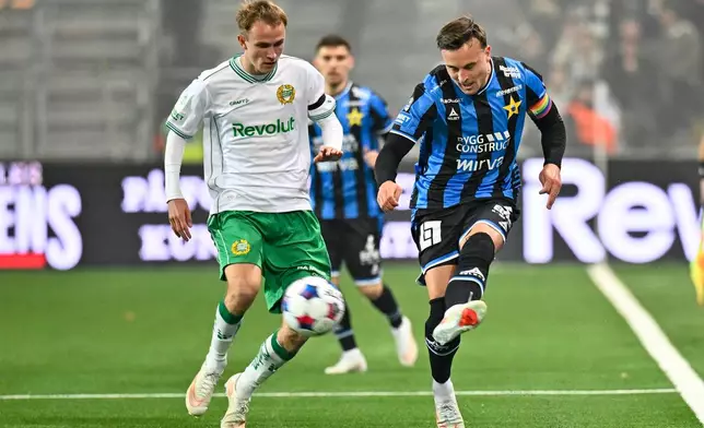 Sirius' Henrik Ronnlof Castegren, right, plays the ball as Hammarby's Victor Stange Lind closes induring the Swedish league soccer match between Hammarby IF and IK Sirius FK in Stockholm, Sweden, Thursday, Oct. 29, 2026. (Anders Wiklund/TT News Agency via AP)