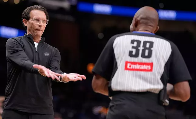 Atlanta Hawks head coach Quin Snyder speaks to referee Michael Smith in the first half of a preseason NBA basketball game against the Memphis Grizzlies, Monday, Oct. 5, 2026, in Atlanta. (AP Photo/Mike Stewart)