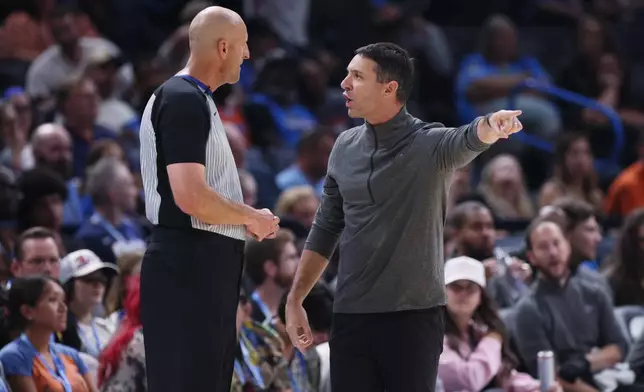 Oklahoma City Thunder head coach Mark Daigneault, right, talks to referee Eric Dalen, left, during the second half of a preseason NBA basketball game against the Indiana Pacers, Tuesday, Oct. 13, 2026, in Oklahoma City. (AP Photo/Nate Billings)