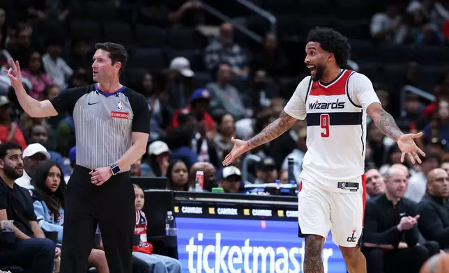 Washington Wizards forward Justin Champagnie (9) argues a foul call made by referee Ben Taylor, left, during overtime of a preseason NBA basketball game against the Detroit Pistons in Washington, Saturday, Oct. 10, 2026. (AP Photo/Terrance Williams)