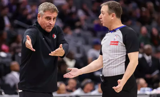 Portland Trail Blazers head coach Micah Nori, left, agrees with referee Scott Twardoski, right, during the first half of a preseason NBA basketball game against Sacramento Kings Tuesday, Oct. 13, 2026, in Sacramento, Calif. (AP Photo/Scott Marshall)