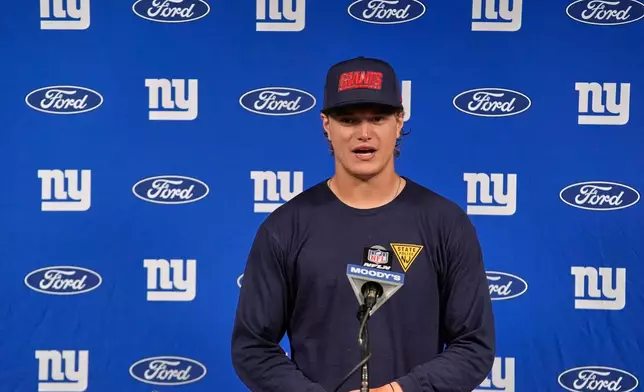 New York Giants quarterback J.J. McCarthy talks with reporters following an NFL football game against the Houston Texans in Houston, Sunday, Oct. 25, 2026. (AP Photo/Gerald Herbert)