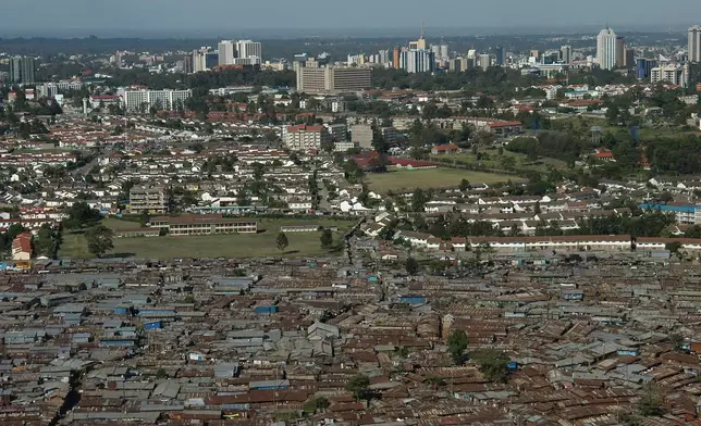 FILE -An aerial view of the slum of Kibera with the Nairobi skyline in the background, Kenya, Jan. 4, 2008. (AP Photo/Riccardo Gangale, File)