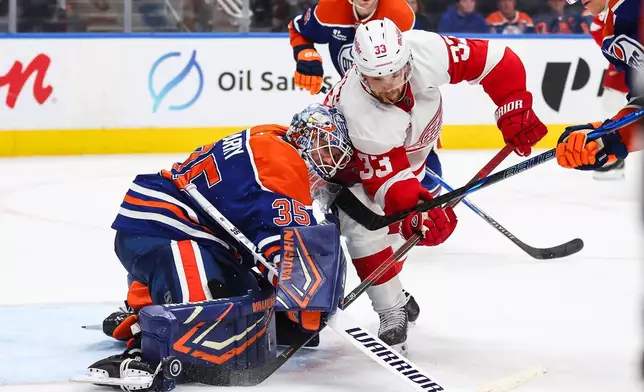Edmonton Oilers goaltender Tristan Jarry (35) battles against Detroit Red Wings' Viktor Arvidsson (33) during third period NHL hockey action in Edmonton, Alberta, Monday, Oct. 26, 2026. (Codie McLachlan/The Canadian Press via AP)