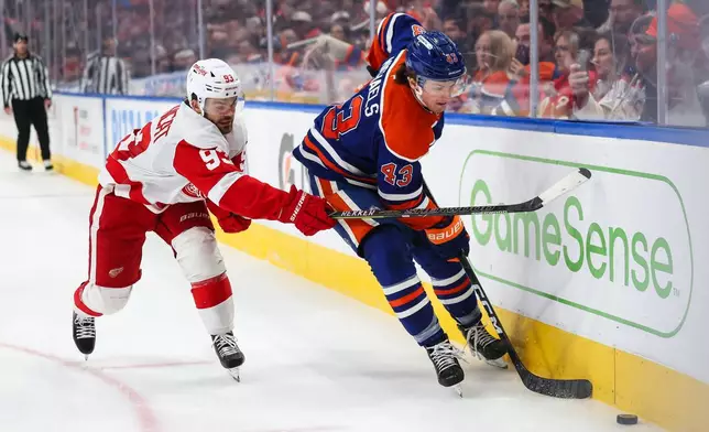 Edmonton Oilers' Owen Michaels (43) battles against Detroit Red Wings' Alex DeBrincat (93) during third period NHL hockey action in Edmonton, Alberta, Monday, Oct. 26, 2026. (Codie McLachlan/The Canadian Press via AP)