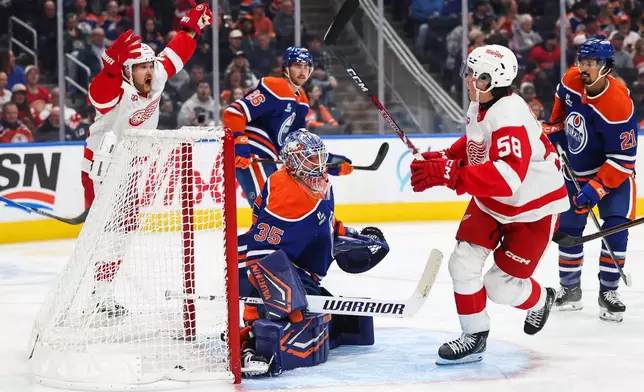 Edmonton Oilers goaltender Tristan Jarry (35) reacts as Detroit Red Wings' Viktor Arvidsson (33) and Emmitt Finnie (58) celebrate Finnie's goal during third period NHL hockey action in Edmonton, Alberta, Monday, Oct. 26, 2026. (Codie McLachlan/The Canadian Press via AP)