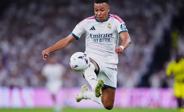 Real Madrid's Kylian Mbappe controls the ball during the La Liga soccer match between Real Madrid and Villarreal in Madrid, Spain, Saturday, Oct. 10, 2026. (AP Photo/Manu Fernandez)