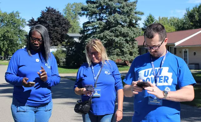 JJ Jewell, from right, Kim Avouris and LaShawn Barnett canvass for the United Auto Workers union in Shelby Township, Mich., Saturday, Sept. 26, 2026. (AP Photo/Jacqueline GaNun)