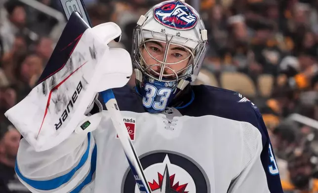 Winnipeg Jets goaltender Clay Stevenson takes a timeout during the second period of an NHL hockey game against the Pittsburgh Penguins in Pittsburgh, Monday, Oct. 5, 2026. (AP Photo/Gene J. Puskar)