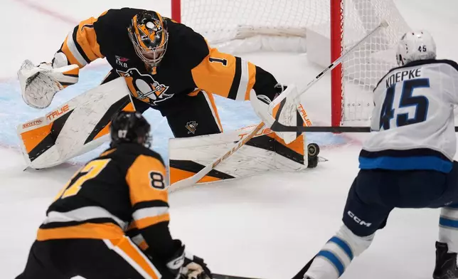 Pittsburgh Penguins goaltender Sergei Murashov (1) stops a shot by Winnipeg Jets' Cole Koepke (45) during the first period of an NHL hockey game in Pittsburgh, Monday, Oct. 5, 2026. (AP Photo/Gene J. Puskar)