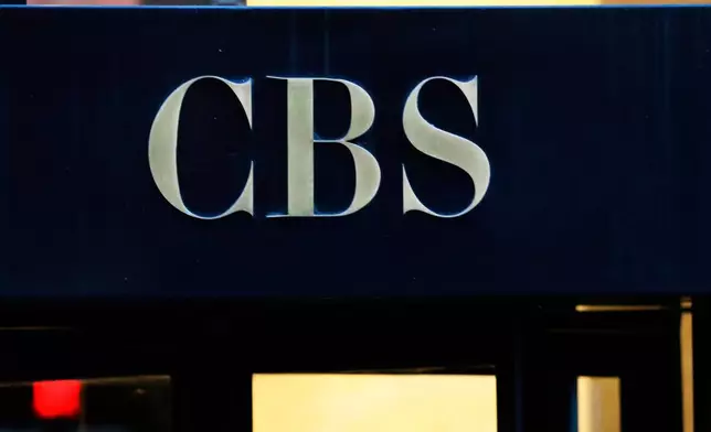FILE - The CBS logo at the entrance to its headquarters, in New York Dec. 6, 2018. (AP Photo/Mark Lennihan, File)