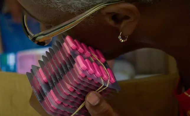 Silvia Perez, a volunteer with the "Medicine Is Not for Sale" community project, prepares medicine for free distribution in Havana, Cuba, Thursday, Oct. 1, 2026. (AP Photo/Ramon Espinosa)