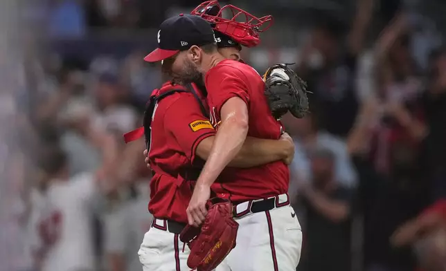 Atlanta Braves pitcher Chris Sale, right, hugs catcher Drake Baldwin, left, after the final out against the Philadelphia Phillies in the ninth inning during Game 3 of baseball's NL Wild Card Series, Thursday, Oct. 1, 2026, in Atlanta. (AP Photo/Brynn Anderson)