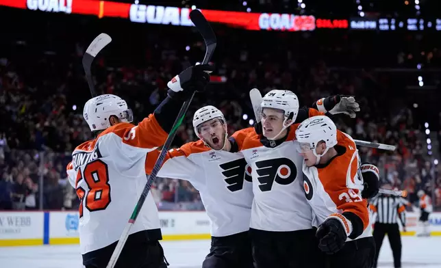 Philadelphia Flyers' Matvei Michkov, from right, Porter Martone, David Jiricek, and Michael Bunting celebrate after Michkov's goal during the second period of an NHL hockey game against the Ottawa Senators Saturday, Oct. 17, 2026, in Philadelphia. (AP Photo/Matt Slocum)