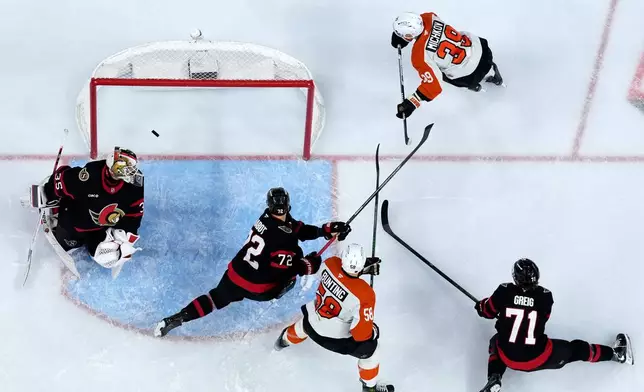 Philadelphia Flyers' Matvei Michkov (39) scores a goal against Ottawa Senators' Linus Ullmark (35) during the second period of an NHL hockey game Saturday, Oct. 17, 2026, in Philadelphia. (AP Photo/Matt Slocum)
