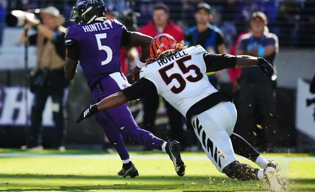 Cincinnati Bengals defensive end Cashius Howell (55) attempts to tackle Baltimore Ravens quarterback Tyler Huntley (5) during the second half of an NFL football game in Baltimore, Sunday, Oct. 25, 2026. (AP Photo/Stephanie Scarbrough)