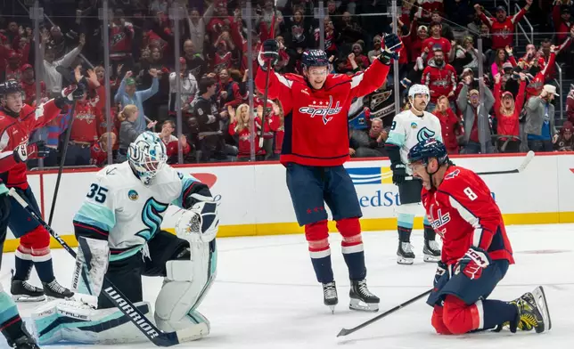 Washington Capitals left wing Alex Ovechkin (8) celebrates after scoring in the first period of an NHL hockey game against the Seattle Kraken, Sunday, Oct. 11, 2026, in Washington. (AP Photo/Nathan Howard)