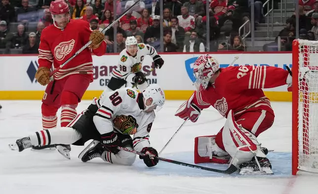 Detroit Red Wings goaltender John Gibson (36) stops a Chicago Blackhawks right wing Roman Kantserov (80) shot in the second period of an NHL hockey game Thursday, Oct. 29, 2026, in Detroit. (AP Photo/Paul Sancya)