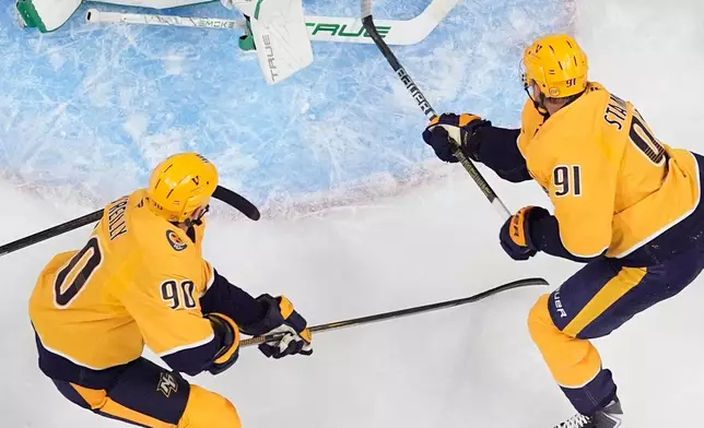 Dallas Stars goaltender Casey DeSmith (1) blocks a shot on goal by Nashville Predators center Steven Stamkos (91) during the first period of an NHL hockey game Saturday, Oct. 3, 2026, in Nashville, Tenn. (AP Photo/George Walker IV)