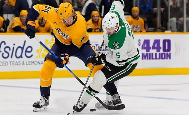 Nashville Predators center Adam Edstrom (84) and Dallas Stars defenseman Lian Bichsel (6) battle for the puck during the first period of an NHL hockey game Saturday, Oct. 3, 2026, in Nashville, Tenn. (AP Photo/George Walker IV)