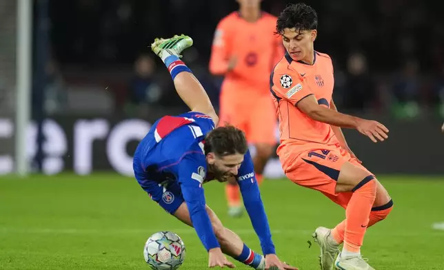 Barcelona's Xavi Espart, right, fights for the ball with PSG's Khvicha Kvaratskhelia during the Champions League opening phase soccer match between Paris Saint-Germain and FC Barcelona in Paris, Tuesday, Oct. 20, 2026. (AP Photo/Thibault Camus)