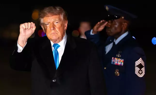 President Donald Trump pumps his fist as he arrives on Air Force One, Monday, Oct. 5, 2026, at Joint Base Andrews, Md. (AP Photo/Alex Brandon)