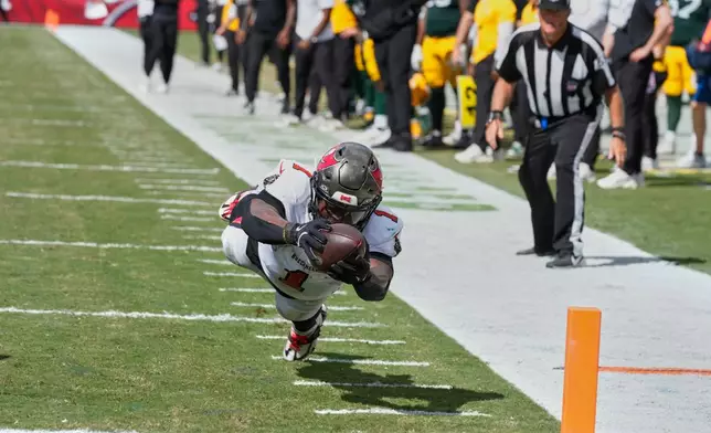 Tampa Bay Buccaneers running back Kenny Gainwell (1) dives to score a touchdown during the second half of an NFL football game against the Green Bay Packers in Tampa, Fla., Sunday, Oct. 4, 2026. (AP Photo/Chris O'Meara)