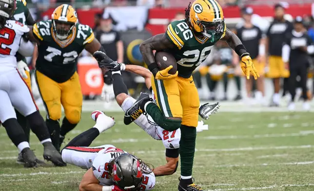 Green Bay Packers running back Kaleb Johnson (26) avoids a tackle during the second half of an NFL football game against the Tampa Bay Buccaneers in Tampa, Fla., Sunday, Oct. 4, 2026. (AP Photo/Jason Behnken)