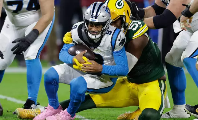 Green Bay Packers defensive end Dani Dennis-Sutton (51) sacks Carolina Panthers quarterback Bryce Young (9) during the second half of an NFL football game in Green Bay, Wis., Thursday, Oct. 29, 2026. (AP Photo/Matt Ludtke)