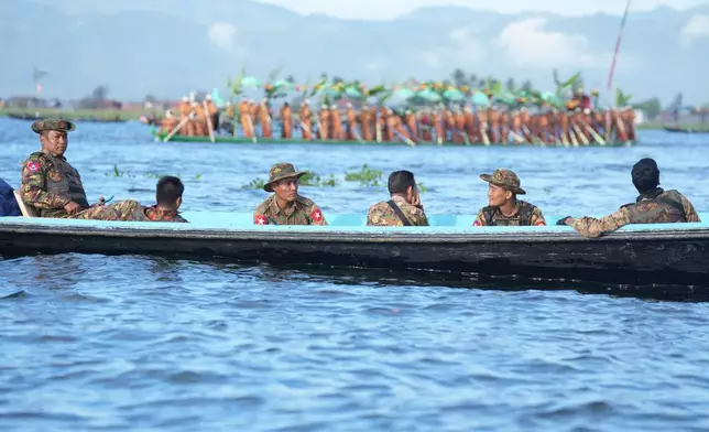 Soldiers provide security during the Phaung Daw Oo pagoda festival on Inle Lake, southern Shan State, Myanmar, Friday, Oct. 16, 2026. (AP Photo/Thein Zaw)