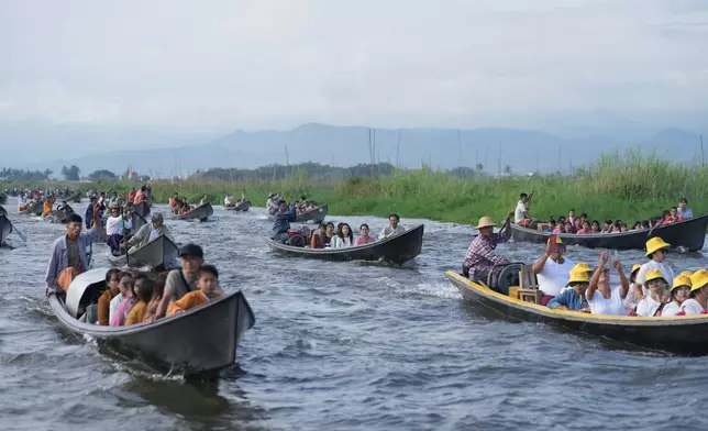 People participate in the Phaung Daw Oo pagoda festival on Inle Lake, southern Shan State, Myanmar, Thursday, Oct. 15, 2026. (AP Photo/Thein Zaw)
