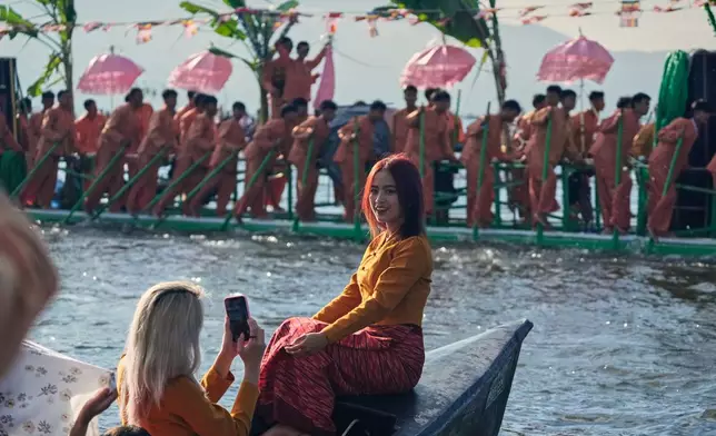 A girl poses for photos during the Phaung Daw Oo pagoda festival on Inle Lake, southern Shan State, Myanmar, Friday, Oct. 16, 2026. (AP Photo/Thein Zaw)