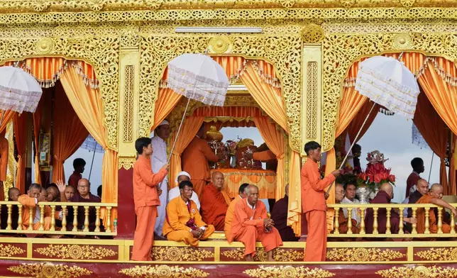 A barge carry Buddha statues float on Inle Lake during the Phaung Daw Oo pagoda festival in southern Shan State, Myanmar, Thursday, Oct. 15, 2026. (AP Photo/Thein Zaw)