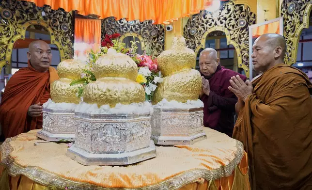 Buddhist monks pray in front of Buddha statues during the Phaung Daw Oo pagoda festival on Inle Lake, southern Shan State, Myanmar, Thursday, Oct. 15, 2026. (AP Photo/Thein Zaw)