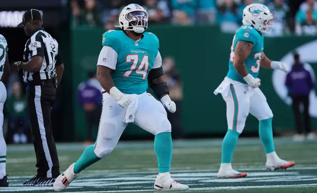Miami Dolphins offensive tackle Kadyn Proctor (74) celebrates a first down by the Dolphins late in the second half an NFL football game against the New York Jets in East Rutherford, N.J., Sunday, Oct. 25, 2026. (AP Photo/Seth Wenig)