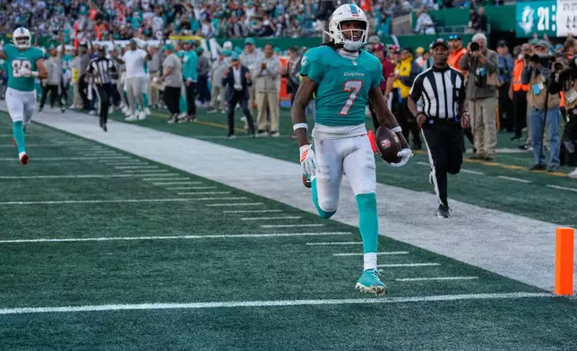 Miami Dolphins wide receiver Caleb Douglas (7) runs for a touchdown in the second half of an NFL football game against the New York Jets in East Rutherford, N.J., Sunday, Oct. 25, 2026. (AP Photo/Seth Wenig)