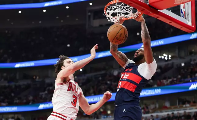 Washington Wizards forward Anthony Davis, left, dunks against Chicago Bulls guard Josh Giddey (3) during the first quarter of an NBA basketball game, Saturday, Oct. 24, 2026, in Chicago. (AP Photo/Jessie Alcheh)