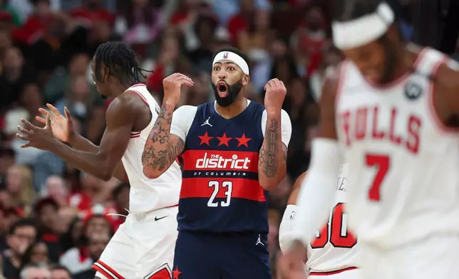 Washington Wizards forward Anthony Davis (23) reacts as Chicago Bulls forward Caleb Wilson, left, gestures and guard Buddy Hield (7) walks during the second quarter of an NBA basketball game, Saturday, Oct. 24, 2026, in Chicago. (AP Photo/Jessie Alcheh)