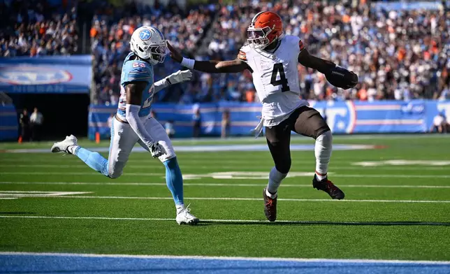Cleveland Browns quarterback Deshaun Watson (4) holds off Tennessee Titans safety Kevin Winston Jr. (23) on his way to scoring a touchdown during the second half of an NFL football game in Nashville, Tenn., Sunday, Oct. 25, 2026. (AP Photo/John Amis)