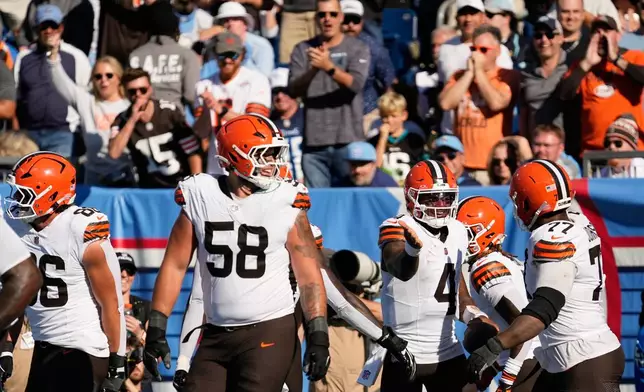 Cleveland Browns quarterback Deshaun Watson (4) celebrates with teammates after scoring a touchdown during the second half of an NFL football game against the Tennessee Titans in Nashville, Tenn., Sunday, Oct. 25, 2026. (AP Photo/George Walker IV)
