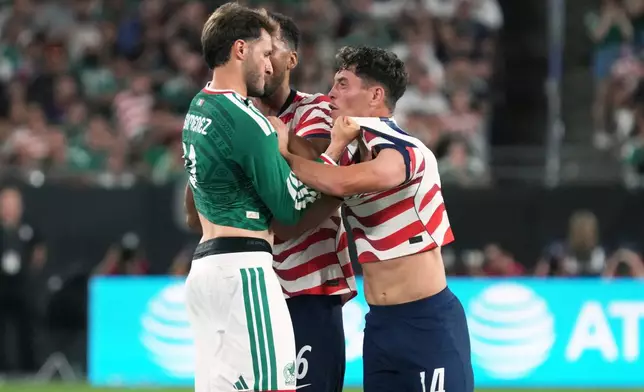 Mexico forward Santiago Gimenez (11) and U.S. midfielder Sabastian Berhalter shove each other in the second half of an international friendly soccer match in Glendale, Ariz., Saturday, Oct. 3, 2026. (AP Photo/Rick Scuteri)