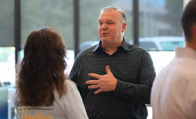 Keith Castello has a conversation at Coram Deo Academy in Flower Mound, Texas, Tuesday, Aug. 11, 2026. (AP Photo/LM Otero)