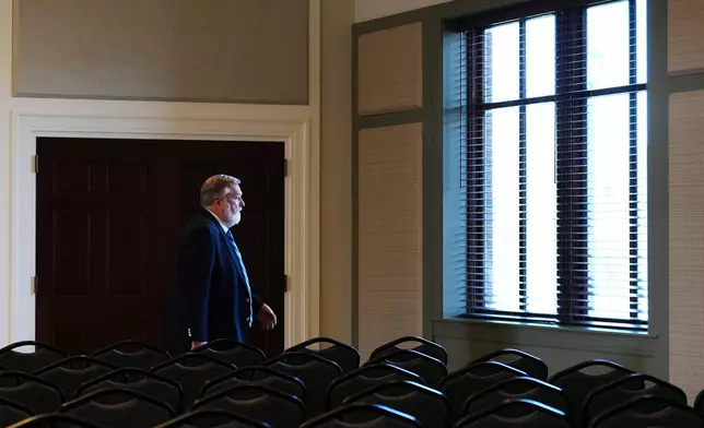 FILE - Pastor Doug Wilson walks through the church hall after Sunday services at the new campus for Christ Church and its Logos School, Sunday, April 6, 2025, in Moscow, Idaho. (AP Photo/Lindsey Wasson, File)